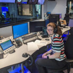 Photograph of Elizabeth Barsotti in-action producing podcast at BBC Radio Science Unit.