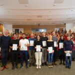 LMB prize winners with certificates in the Max Perutz Lecture Theatre with clapping audience