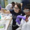 Volunteer and boy at the Chromatography activity